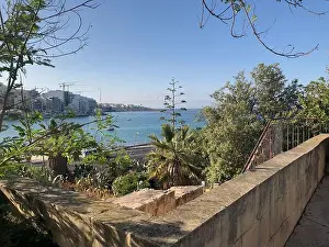 Sea View Prints: View on the coastline of the seaside Maltese city Bugibba near a garden, Malta