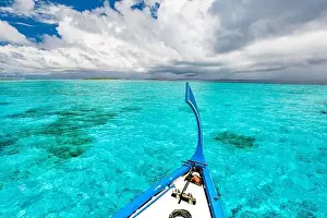 View from the deck of the traditional Maldivian wooden fishing boats on landscape of tropical island with a sandy beach and palm trees