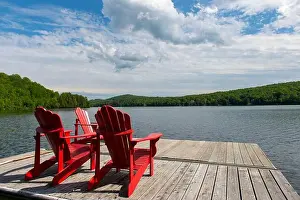 Quebec Province Prints: View of a dock with red Adirondack chairs in Lac Mercier from the Le Petit Train du Nord Bike Path near Old