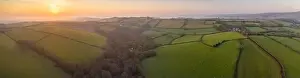 Paddocks Prints: View by drone of early Spring sunrise over the rolling countryside of Devon