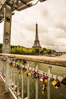 A view of the Eiffel Tower from a love lock bridge in the city of Paris France