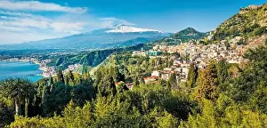 View from flying drone. Amazing morning view of Taormina town and Etna volcano on background