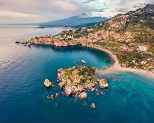View from flying drone. Breathtaking morning view of Bella island and Etna volcano on background