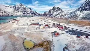 View from flying drone of Flakstad village with Hustinden mount on background