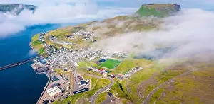 View from flying drone. Foggy morning cityscape of Eidi town