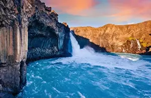 View from flying drone. Impressive summer sunrise on Ingvararfoss waterfall