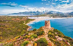 View from flying drone. Incredible summer scene of Torre di Porto Giunco tower on Carbonara cape
