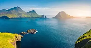 View from flying drone. Magnificent summer scene of Faroe Islands and Tindholmur cliffs on background