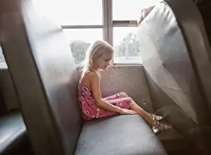 Public Transportation Prints: Side view of girl sitting by window in bus