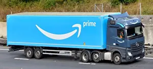 Promoting Prints: Side & front view of grey hgv lorry truck blue Amazon supply chain articulated delivery trailer driver & logo brand