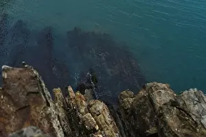 Sultry Prints: View from a high cliff to the blue turquoise clear sea and coral reefs under the water