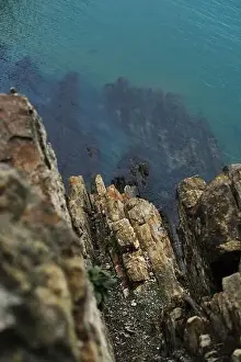 Sultry Prints: View from a high cliff to the blue turquoise clear sea and coral reefs under the water