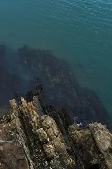 Sultry Prints: View from a high cliff to the blue turquoise clear sea and coral reefs under the water