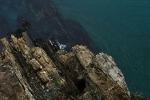 Sultry Prints: View from a high cliff to the blue turquoise clear sea and coral reefs under the water