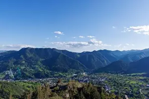 Mountain Town Prints: View from high rock to old village town of Smolyan with green meadows for cattle walking and ancient houses