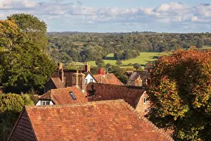 View of High Weald landscape behind village cottage rooftops, Burwash, East Sussex, England, United Kingdom, Europe