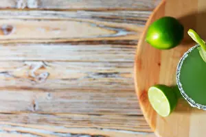 Chilled Prints: Top View of Lime Margarita with Salt Rim on Wooden Board
