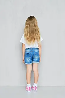 Sneakers Prints: Back view of little child girl in white t-shirt