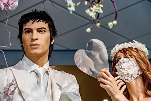 Masks Prints: A view a male and female mannequins dressed in bridal wear with the female mannequin wearing a laced bridal facemask
