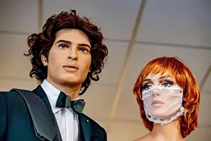 Masks Prints: A view male and female mannequins dressed in bridal wear with the female mannequin wearing a laced bridal facemask