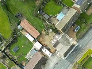 Aerial Cityscape Prints: Top down view of a mixture of old and modern houses and bungalows seen at the edge of an East Anglian village