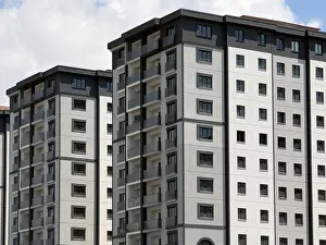 Grey Prints: View of modern residential apartment buildings with grey and white facades under a bright sky in Bagcilar