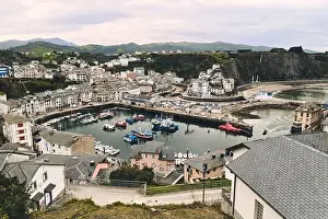 Moody Sky Prints: Above view to the moored boats in harbour of Luarca during cloudy winter day