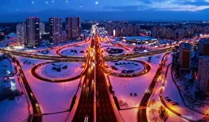 Interchange Prints: Top view, multilevel transport interchange in the evening city. Winter landscape