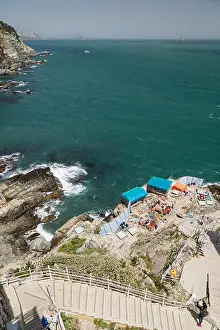 Sea Water Prints: View of ocean and stairs going to simple shacks at a cliff below at the Taejongdae Resort Park in Busan