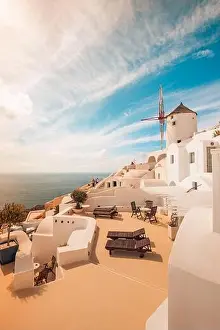 View of Oia the most beautiful village of Santorini Island in Greece. Idyllic summer travel landscape, holiday. Romantic chaise lounge couple vacation