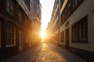Urban Village Prints: View of old town with stone street in Europe in beautiful evening light at sunset