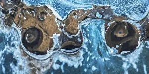 Lake Shore Prints: Top view picturesque drone view of Skutustadagigar pseudocraters covered with snow located on shore of Lake Myvatn