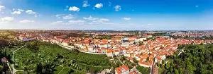 Charles Bridge Prints: View of Prague featuring historic castle and vibrant rooftops on a sunny day in summer