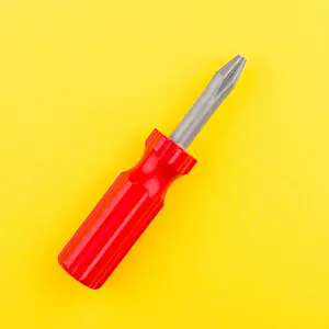 Screwdriver Prints: top view of red plastic toy screwdriver on yellow background