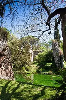 Latina Prints: View of the river Ninfa among trees and ruins in spring in Garden of Ninfa, Lazio, Italy