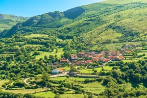 Lush Foliage Prints: View of a rustic village surrounded by green mountains, Tudanca, Cantabria, Spain