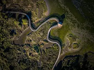 Top view of sea with wooden walkway - Aerial top view of wooden bridge pathway over marshy river with vegetation