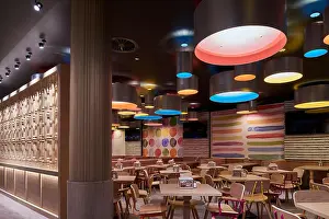 Partition Prints: View into separate restaurant area with timber screens and coloured feature lighting and painted wall