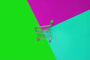 Shopper Prints: Top view of empty shopping trolley on colorful bright background
