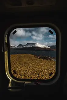 Koltur Prints: View onto the snow-covered shore of Faroese island Streymoy through a helicopter window taken on Koltur during an early