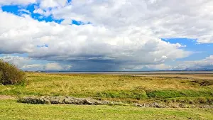 Storm Clouds Prints: View over the Solway Firth shoreline from Scotland towards Cumbria with storm clouds gathering