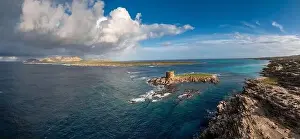Rocky Beach Prints: A view of the Spiaggia la Pelosa with the Pelosa Watchtower near Stintino in Sardinia