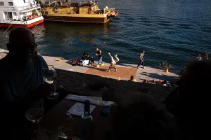 Watching Prints: View of a street performance of dance hip hop breakdance with people watching along the Douro River in Porto