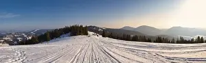 Hill Glacier Prints: View of the stunning winter panorama of the snowy slopes and hills among the lush white clouds