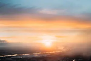 Top View Of Sunset Sunrise Over Earth. Aerial View From High Altitude Flight Of Aircraft On Sunny Sunset Sunrise In Winter. Sunny Dawn Sky
