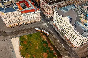 Boulevard Prints: Top view of a tram in Budapest traveling down the street