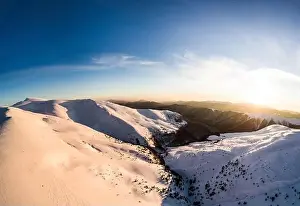 Hill Glacier Prints: Top view of an unforgettable ski slope covered with snow located in the mountains in the northern country on a sunny
