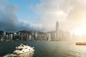 View of Victoria Harbour with Hong Kong skyscraper office buildings and cruise ship at sunset time in Hong Kong. Asia