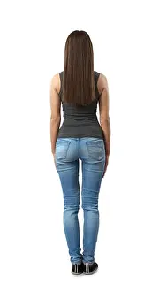 Ideal Prints: Back view of woman in gray sleeveless top and blue jeans standing with arms at sides isolated on white background