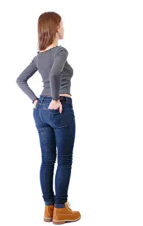 Backside Prints: Back view of a woman in jeans. girl watching